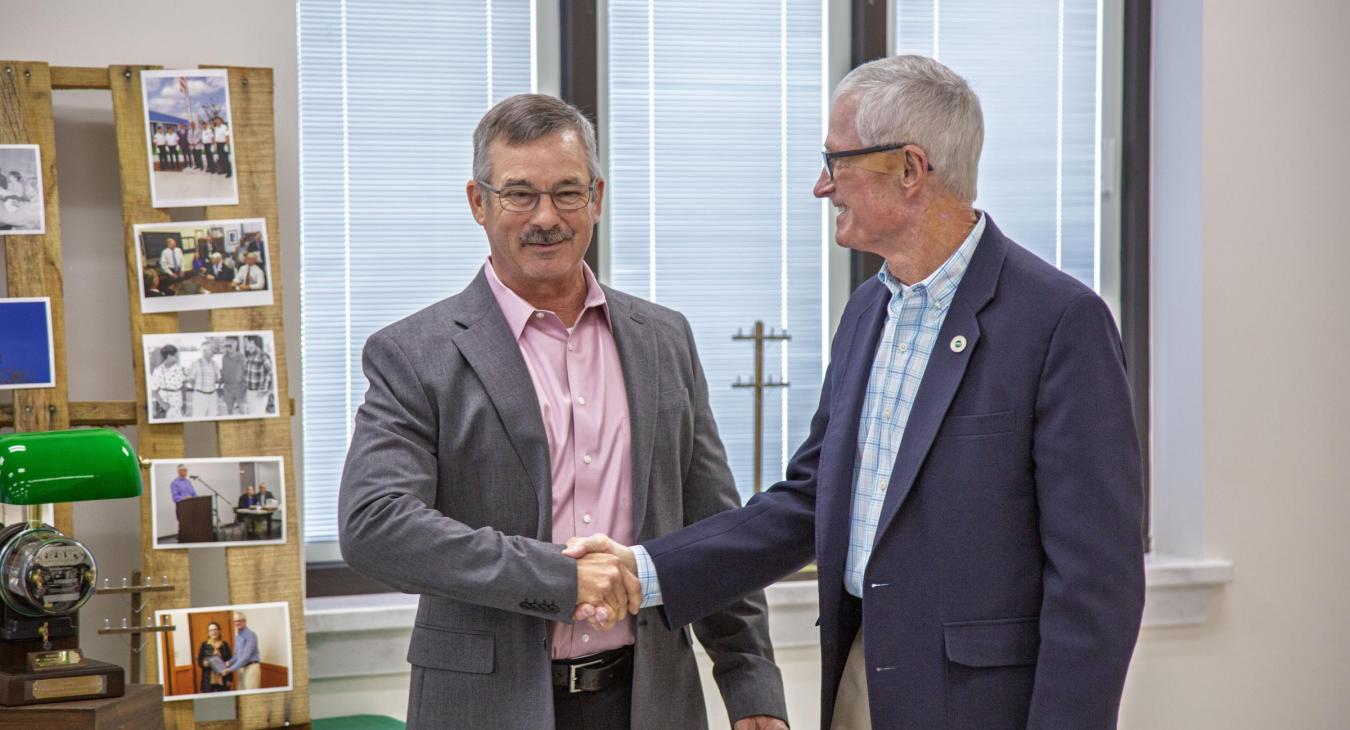 GM/CEO Andy Chaff shakes hands with Kelley Smith during Smith's retirement gathering.