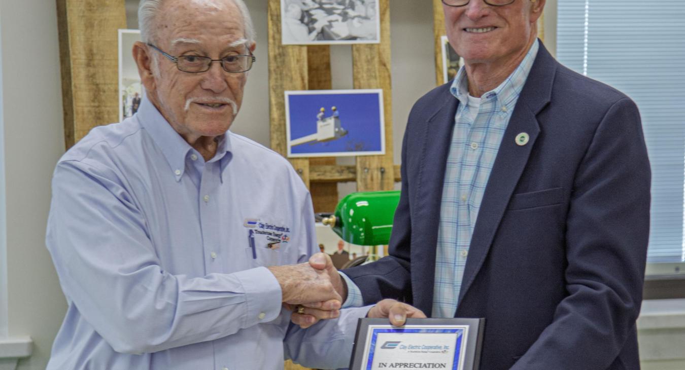 Trustee Dewitt Hersey presents Kelley Smith with a service plaque.